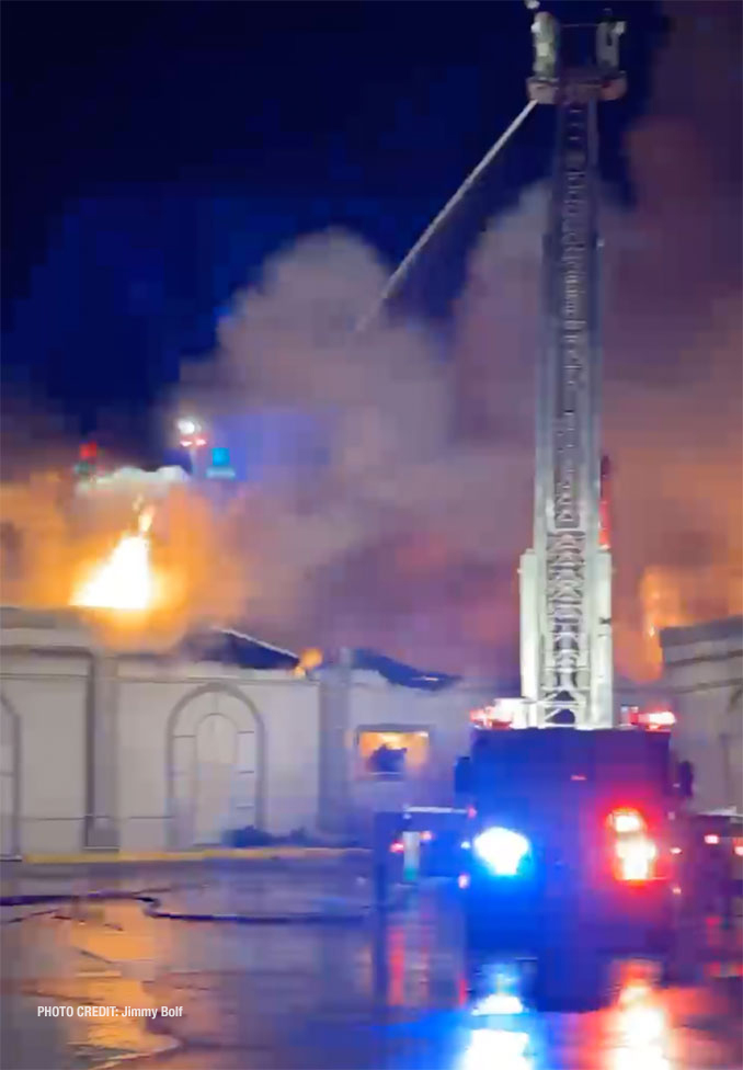 Tower ladder at work at fire scene at D'Andrea Banquets and Conference Center early Saturday morning, April 16, 2022 (PHOTO CREDIT: Jimmy Bolf)