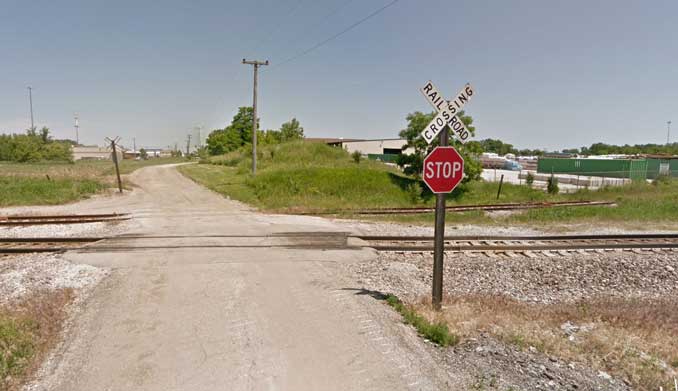 View northbound on Hainesville Road at the Milwaukee District North Metra crossing showing the existing control devices on Monday, May 23, 2022 (Image capture June 2012 ©2022 Google)
