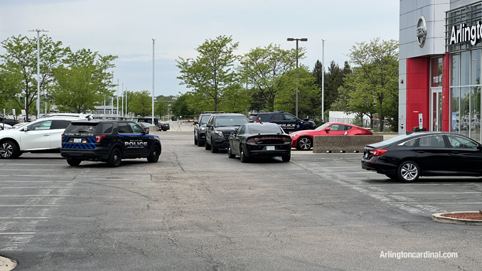 Police at the front of Arlington Nissan after a black Chevrolet pickup truck and a gold Range Rover were stolen