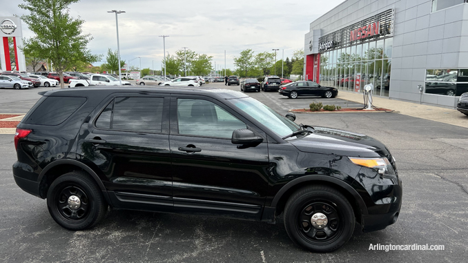 Police at the front of Arlington Nissan after a black Chevrolet pickup truck and a gold Range Rover were stolen