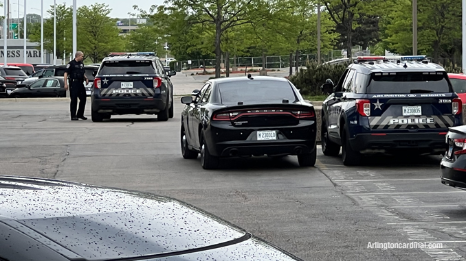 Police at the front of Arlington Nissan after a black Chevrolet pickup truck and a gold Range Rover were stolen