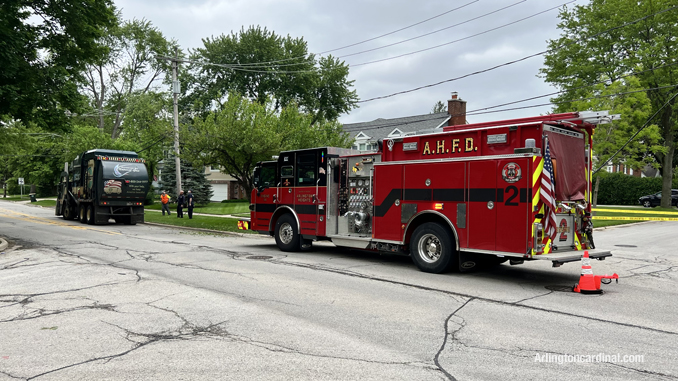 Groot garbage truck and Arlington Heights Fire Department Engine 2 on Euclid Avenue while downed lines were being secured