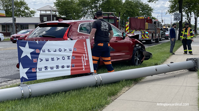Light pole down next to the red Volvo that struck the light pole at Arlington Heights Road and Rand Road in Arlington Heights