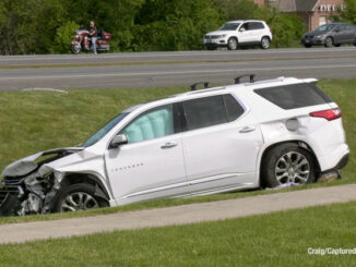 White Chevy Traverse in a ditch with airbag deployment after a crash at Rand Road and Clover Hill Lane in Lake Zurich (PHOTO CREDIT: Craig/Captured New)