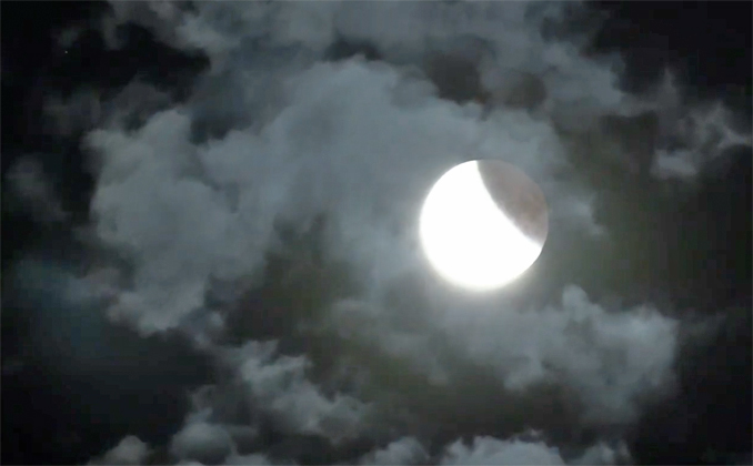 Total Lunar Eclipse near ending of partial lunar eclipse when some clouds were still passing by.