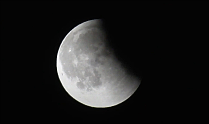 Total Lunar Eclipse near the ending of the latter partial lunar eclipse early Sunday morning around 12:30 to 12:45 a.m.