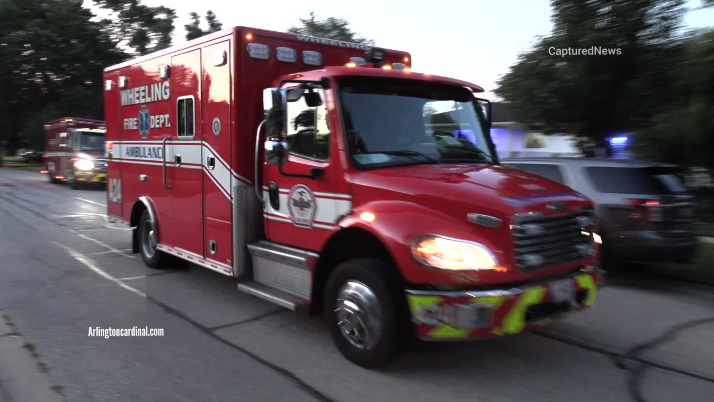 Wheeling paramedics transporting a patient to the hospital from a shooting scene on Fletcher Drive west of Elmhurst Road on Saturday, July 30, 2022