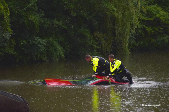 Red pickup truck submerged in a small pond after the driver was rescued in Vernon Hills (PHOTO CREDIT: Max Weingardt)