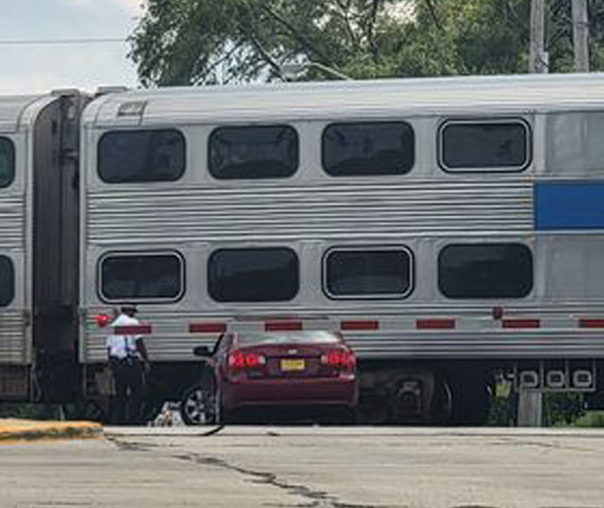 Red sedan in a minor crash with a Metra train at Quentin Road and Colfax Street in Palatine.