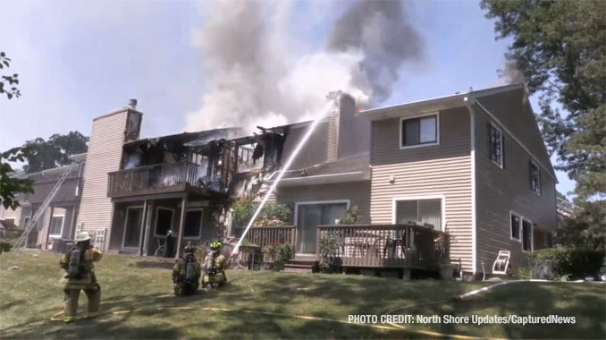 Firefighters work to extinguish fire that was showing at the rear balconies of a townhouse building on Pine Tree Circle in Buffalo Grove (North Shore Updates/CapturedNews)