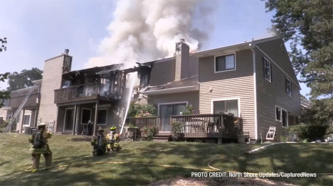 Firefighters work to extinguish fire that was showing at the rear balconies of a townhouse building on Pine Tree Circle in Buffalo Grove (North Shore Updates/CapturedNews)