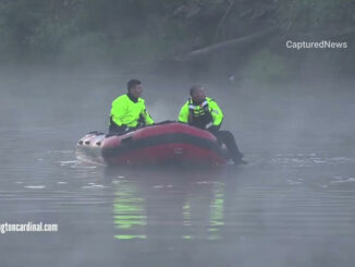 Firefighters in boat at fatal crash scene into the Des Plaines River at Milwaukee Avenue and River Road in Prospect Heights,.