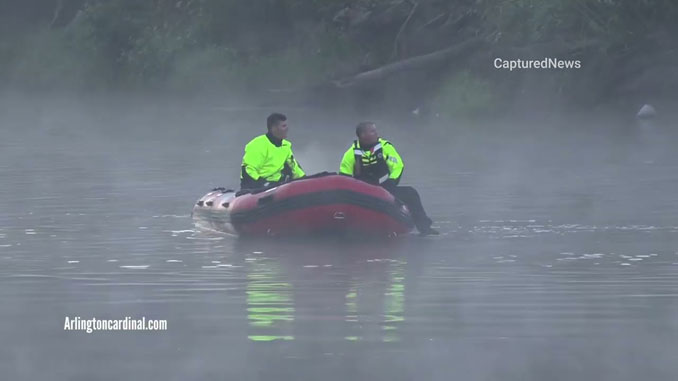 Firefighters in boat at fatal crash scene into the Des Plaines River at Milwaukee Avenue and River Road in Prospect Heights,.