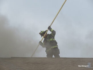 Firefighters venting and checking the roof and attic (PHOTO CREDIT: Max Weingardt)