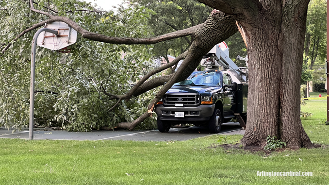 The passenger side of an Arlington Heights Park District aerial bucket truck was crushed by a large tree that fell during a thunderstorm Monday, August 29, 2022