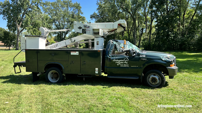 The passenger side of an Arlington Heights Park District aerial bucket truck was crushed by a large tree that fell during a thunderstorm Monday, August 29, 2022