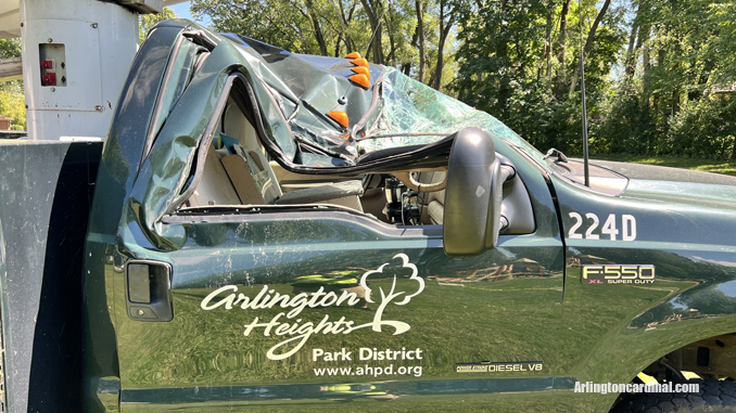 The passenger side of an Arlington Heights Park District aerial bucket truck was crushed by a large tree that fell during a thunderstorm Monday, August 29, 2022