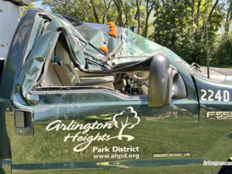 The passenger side of an Arlington Heights Park District aerial bucket truck was crushed by a large tree that fell during a thunderstorm Monday, August 29, 2022