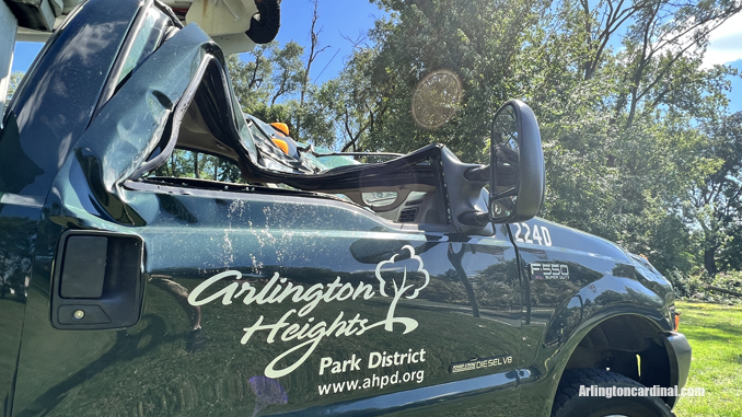 The passenger side of an Arlington Heights Park District aerial bucket truck was crushed by a large tree that fell during a thunderstorm Monday, August 29, 2022