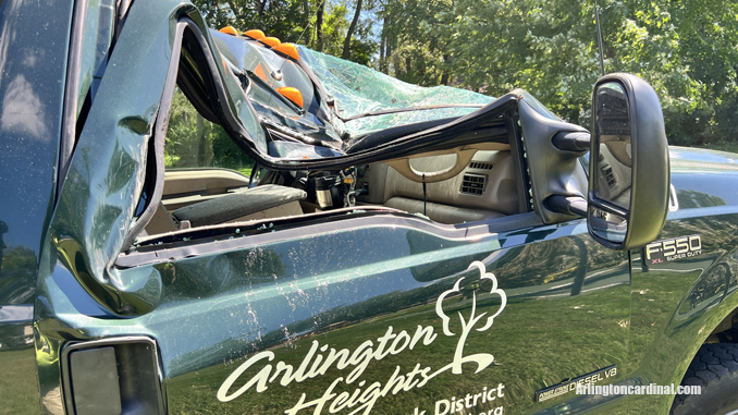 The passenger side of an Arlington Heights Park District aerial bucket truck was crushed by a large tree that fell during a thunderstorm Monday, August 29, 2022