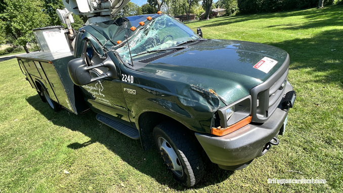 The passenger side of an Arlington Heights Park District aerial bucket truck was crushed by a large tree that fell during a thunderstorm Monday, August 29, 2022