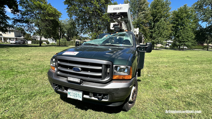 The passenger side of an Arlington Heights Park District aerial bucket truck was crushed by a large tree that fell during a thunderstorm Monday, August 29, 2022