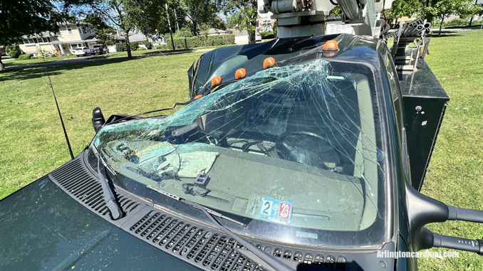 The passenger side of an Arlington Heights Park District aerial bucket truck was crushed by a large tree that fell during a thunderstorm Monday, August 29, 2022