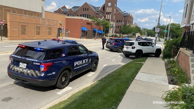 White Jeep Renegade up on the sidewalk on the eastbound side of Sigwalt Street near Arlington Heights Road in Arlington Heights