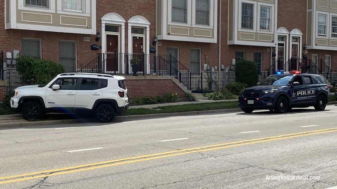 White Jeep Renegade up on the sidewalk on the eastbound side of Sigwalt Street near Arlington Heights Road in Arlington Heights