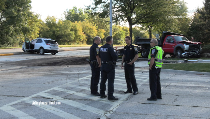Police officers meet to prepare for a serious traffic crash investigation at Lake Cook Road and Wilke Road in Arlington Heights.