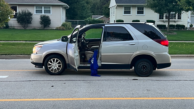 Victim’s vehicle In street during police investigation on Rohlwing Road north of Campbell Street in Rolling Meadows Wednesday morning, September 21, 2022