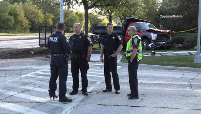 Police officers meet to prepare for a serious traffic crash investigation at Lake Cook Road and Wilke Road in Arlington Heights.