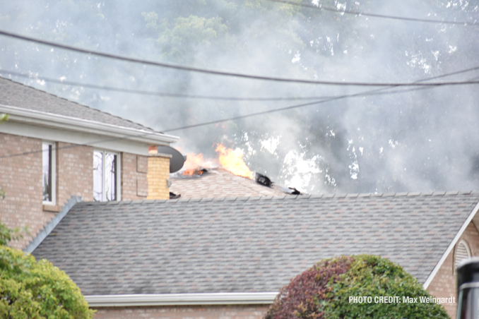 Fire showing at the peak of the roof at a house fire on Mount Prospect Road in Des Plaines, Monday, September 26, 2022 (PHOTO CREDIT: Max Weingardt)