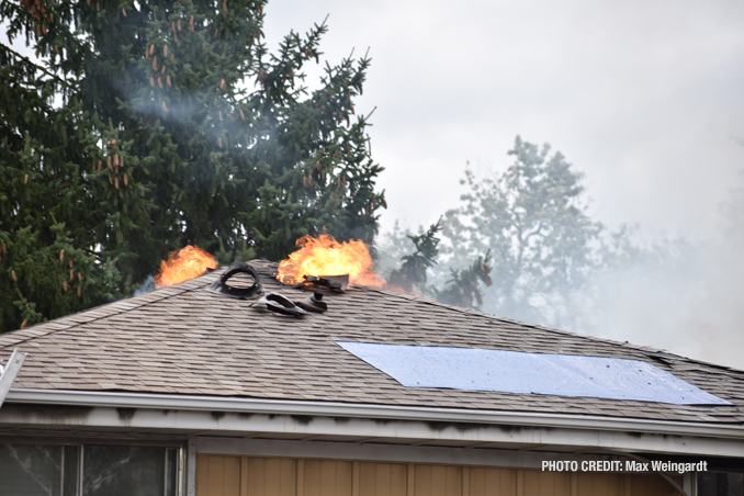 Fire showing at the peak of the roof at a house fire on Mount Prospect Road in Des Plaines, Monday, September 26, 2022 (PHOTO CREDIT: Max Weingardt)
