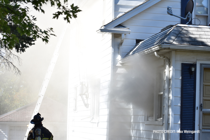 Smoke from a first floor window at a house fire on Western Avenue in Highland Park on Friday, September 30, 2022 (PHOTO CREDIT: Max Weingardt)
