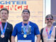 FIREFIGHTER CHALLENGE: Eric Rose, Huntley Fire Protection District, 1st Place time 1:28.47 (center); Richard Estes, Irving, TX Fire, 2nd Place time 1:29.97 (right); and Nate Skewes, Waukegan Fire, 3rd Place time 1:32.52 (left).