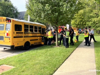 Police and paramedics documenting the crash while some firefighters handed out stickers for the children in the bus.