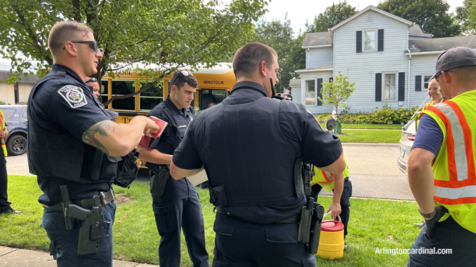 Police and paramedics documenting the crash while some firefighters handed out stickers for the children in the bus.