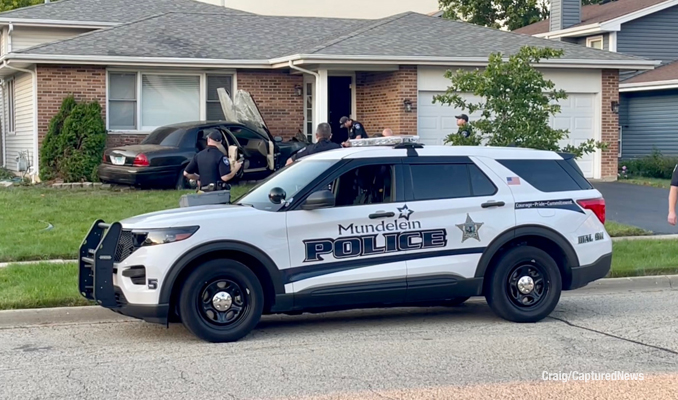 Mundelein police at crash scene involving a car against a house on Quigley Street in Mundelein on Thursday, September 8, 2022