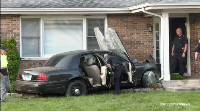 Ford Crown Victoria at crash scene involving the car against a house on Quigley Street in Mundelein on Thursday, September 8, 2022