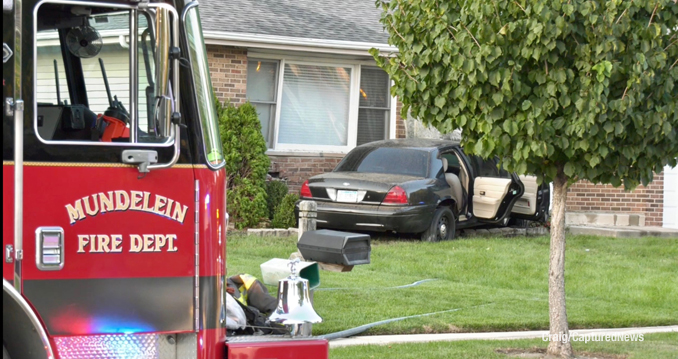 Mundelein Fire Department engine at the scene of a vehicle fire after a crash against a house on Quigley Street in Mundelein (Craig/CapturedNews)