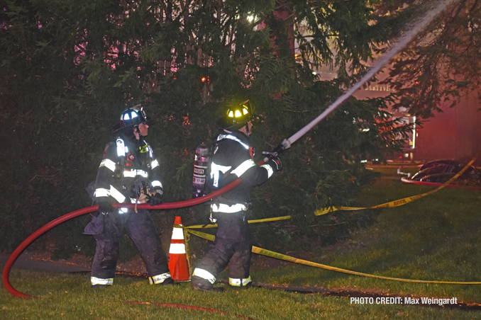 Firefighters attacking the house fire from the exterior, known as defensive (PHOTO CREDIT: Max Weingardt)