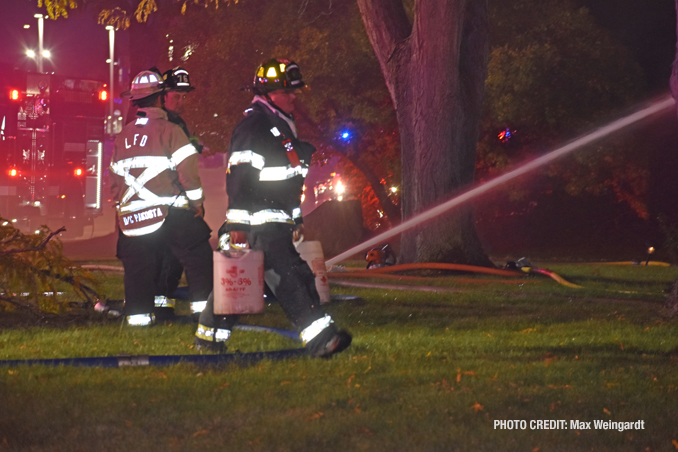 Firefighters attacking the house fire from the exterior, known as defensive (PHOTO CREDIT: Max Weingardt)