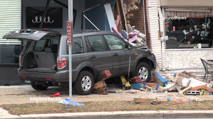Gray Honda SUV after a double fatal crash over a sidewalk and against the walls of two buildings on Northwest Highway in Des Plaines on Sunday, November 27, 2022