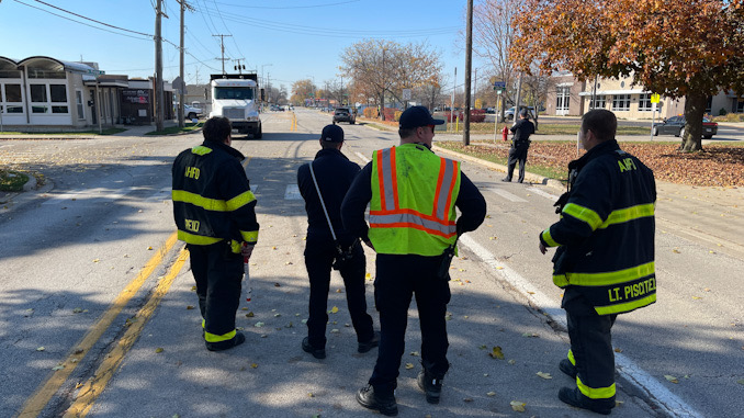 Police and firefighters putting together a plan to secure the scene where powers lines were down on Euclid Avenue near Ridge Avenue in Arlington Heights