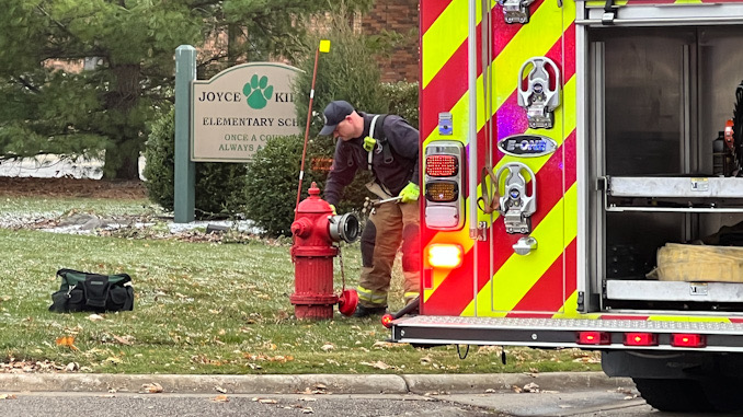 A firefighter at a hydrant at the front of Kilmer School at 655 Golfview Terrace in Buffalo Grove