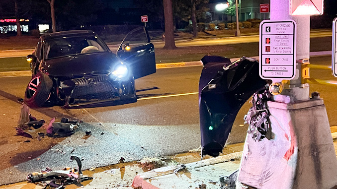 Black Lexus sedan with severe right, front damage after a crash with a traffic signal standard at Palatine Road and Rand Road in Arlington Heights