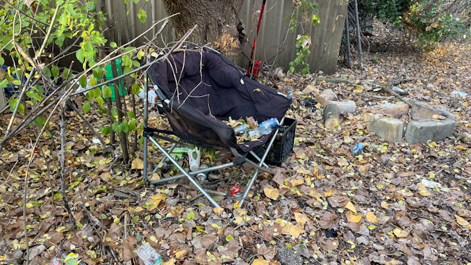 A black chair at a campsite where a homeless man was found dead in Arlington Heights