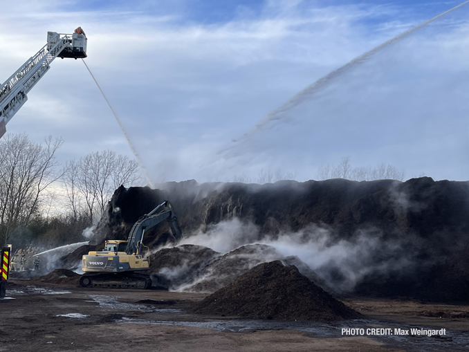 Firefighters direct several streams of water at a pile of burning mulch at the Mulch Center on 23rd Place in North Chicago on Sunday, November 20, 2022 (PHOTO CREDIT: Max Weingardt).