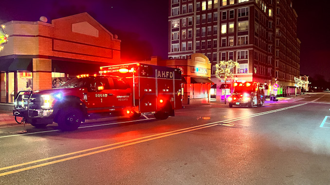 Police and paramedics helping a man down in the underground parking garage under Arlington Town Square in the block of 0-99 South Evergreen Avenue in Arlington Heights on Sunday, December 4, 2022